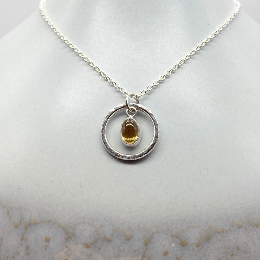 Oval cabochon citrine pendant necklace in silver hammered ring