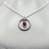 Oval cabochon rhodalite garnet pendant necklace in silver hammered ring