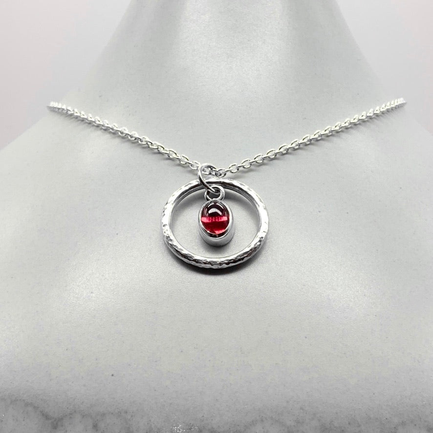 Oval cabochon rhodalite garnet pendant necklace in silver hammered ring