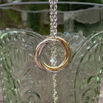 Caldera Russo Russian ring necklace - 18 carat gold and sterling silver pendant - close-up on glass, face-on