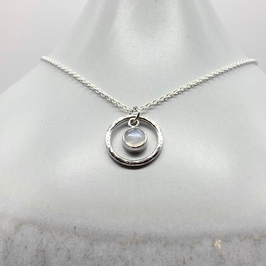 Round cabochon moonstone pendant necklace in silver hammered ring
